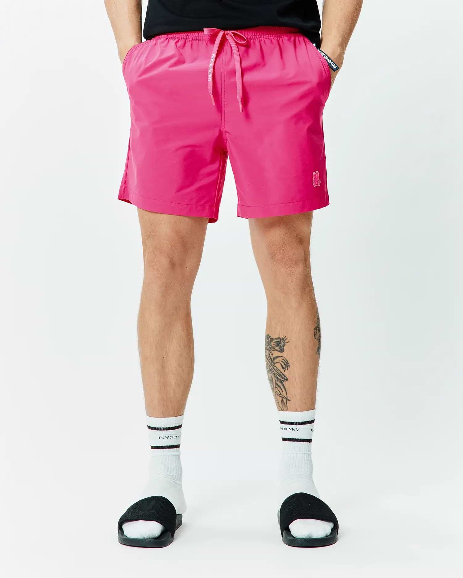 Mens Samos Hydrochromic Printed Swim Trunk 6 in vibrant pink, featuring a relaxed fit, smooth quick-dry fabric, elastic drawstring waist with white Psycho Bunny text, and a small embroidered pink bunny skull logo on the left leg. (3)