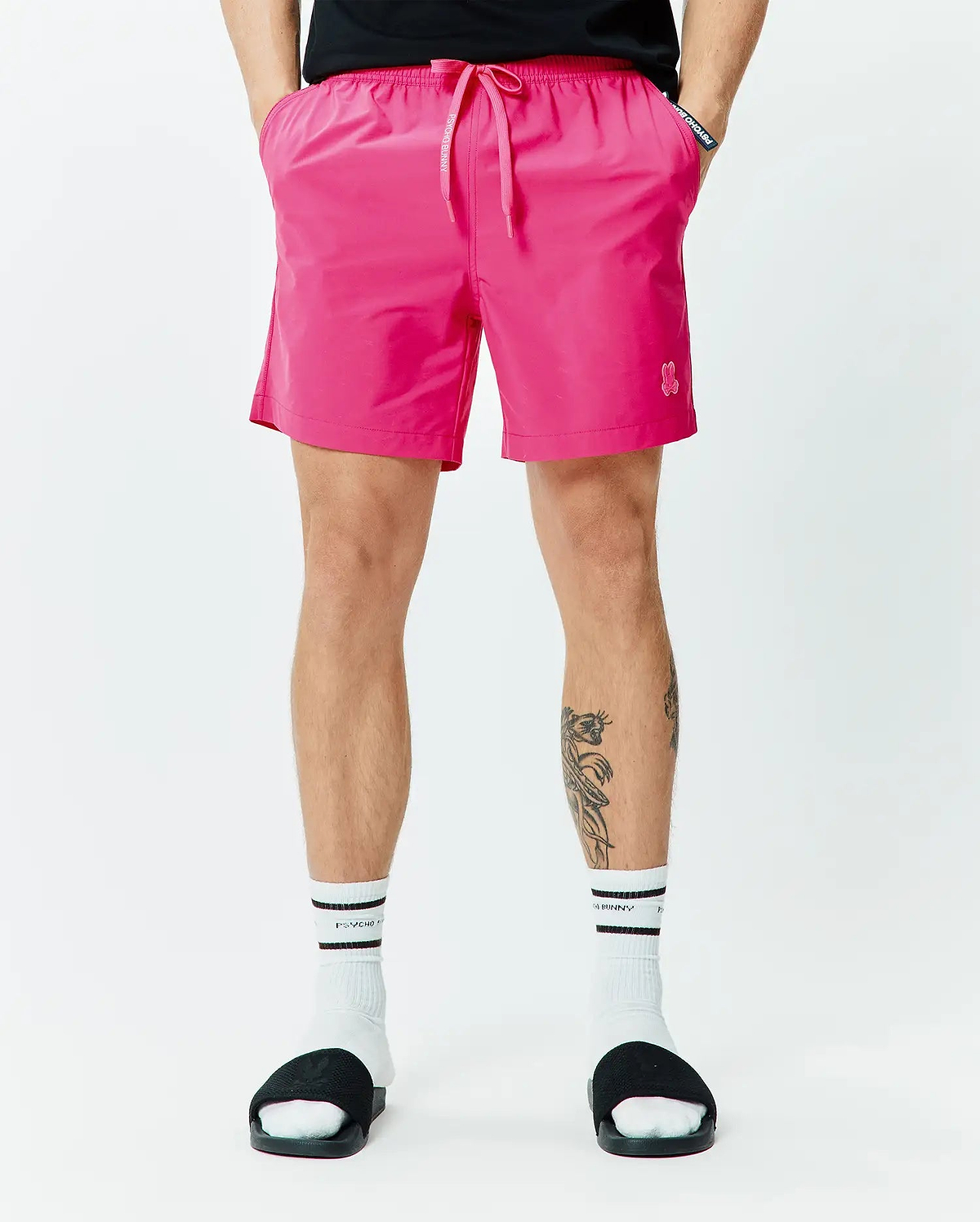 Mens Samos Hydrochromic Printed Swim Trunk 6 in vibrant pink, featuring a relaxed fit, smooth quick-dry fabric, elastic drawstring waist with white Psycho Bunny text, and a small embroidered pink bunny skull logo on the left leg. (3)