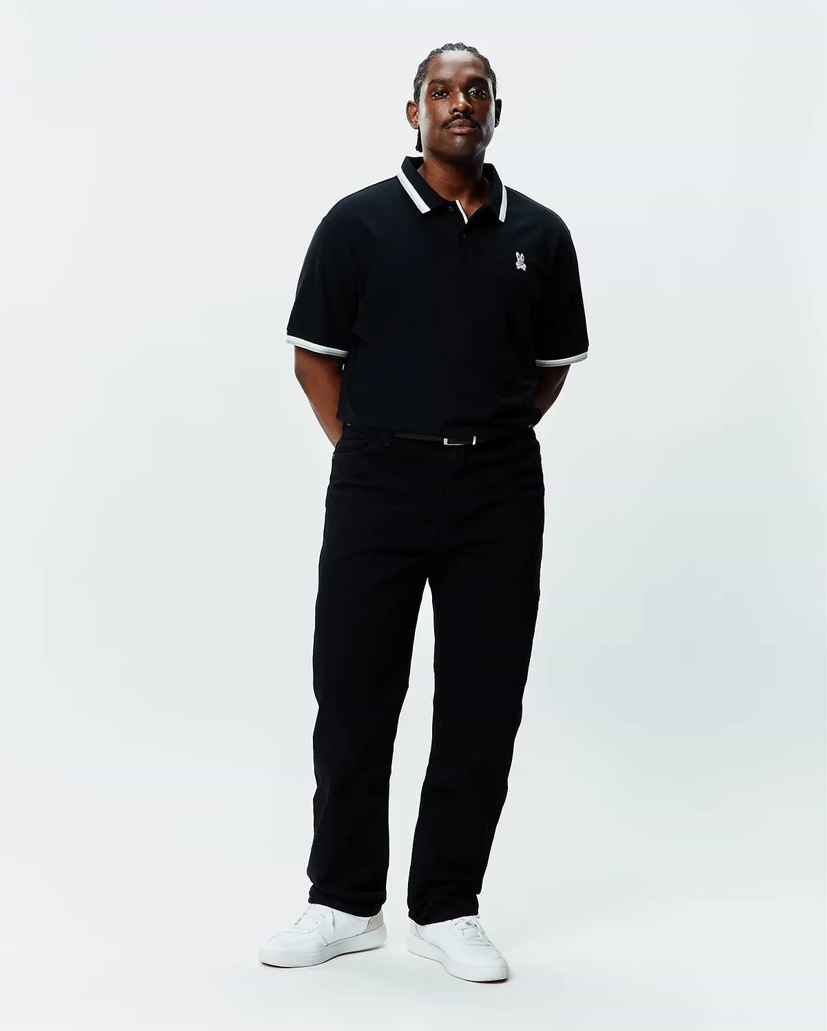 Mens Big And Tall Holden Pique Polo in black pique with white tipping on the collar and cuffs, featuring a small embroidered white Psycho Bunny skull logo on the left chest.