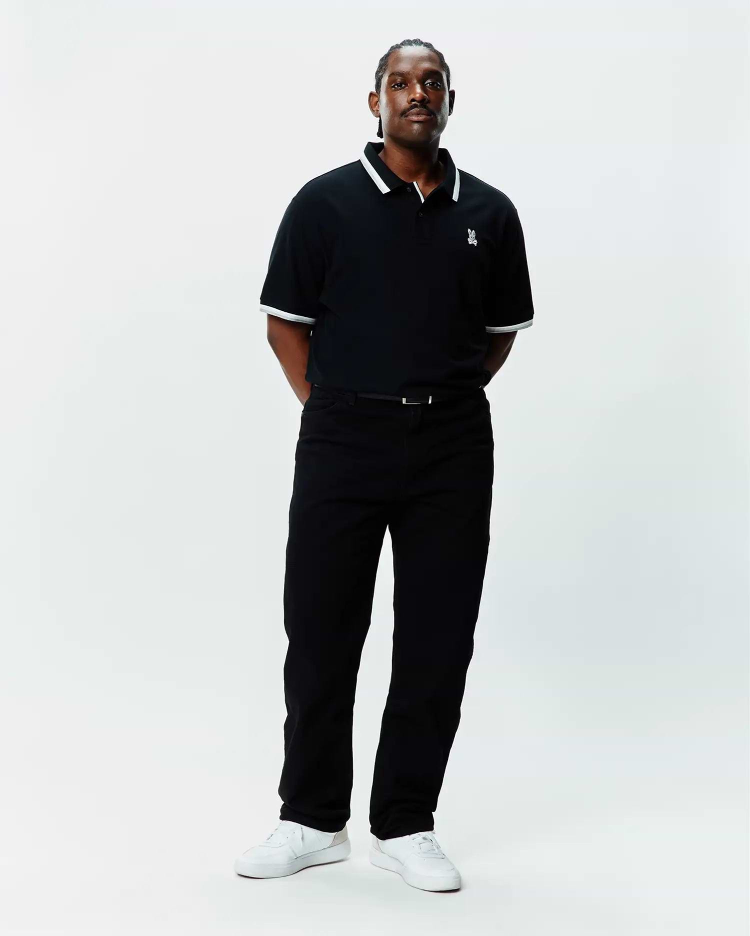 Mens Big And Tall Holden Pique Polo in black pique with white tipping on the collar and cuffs, featuring a small embroidered white Psycho Bunny skull logo on the left chest.