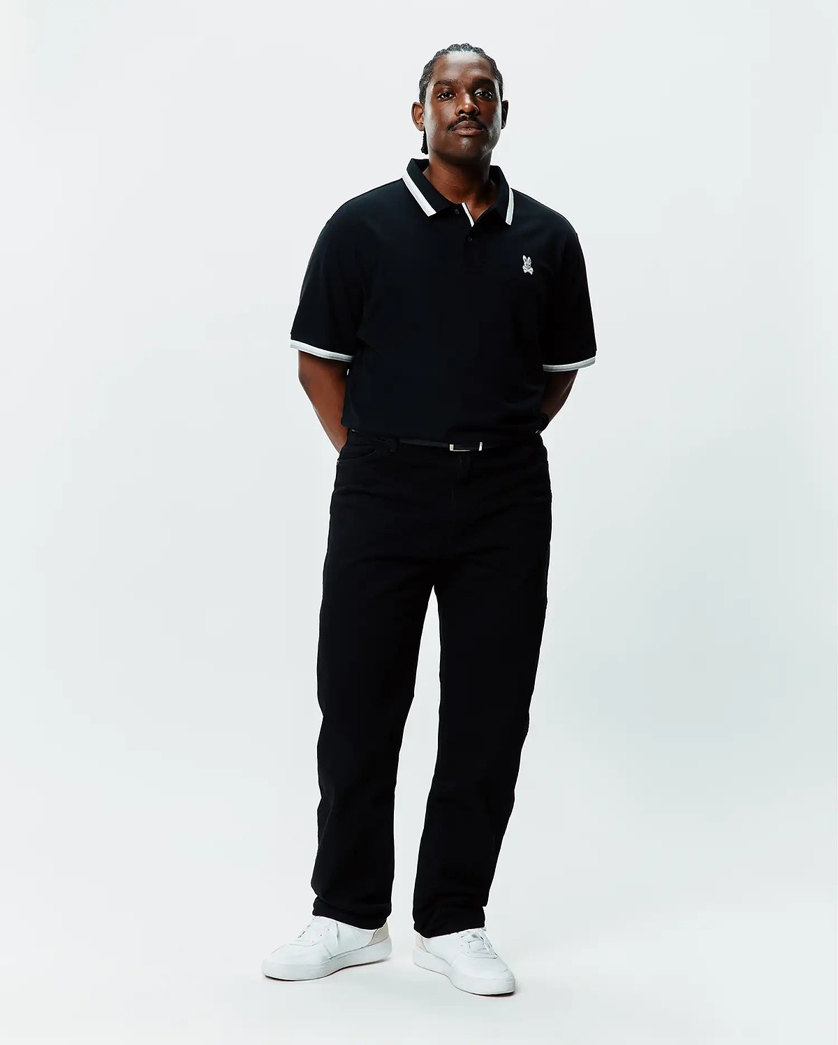 Mens Big And Tall Holden Pique Polo in black pique with white tipping on the collar and cuffs, featuring a small embroidered white Psycho Bunny skull logo on the left chest.