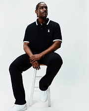Mens Big And Tall Holden Pique Polo in black, featuring a classic fit, pique texture, white tipping on the collar and sleeve cuffs, and a small white embroidered Psycho Bunny skull logo on the left chest.