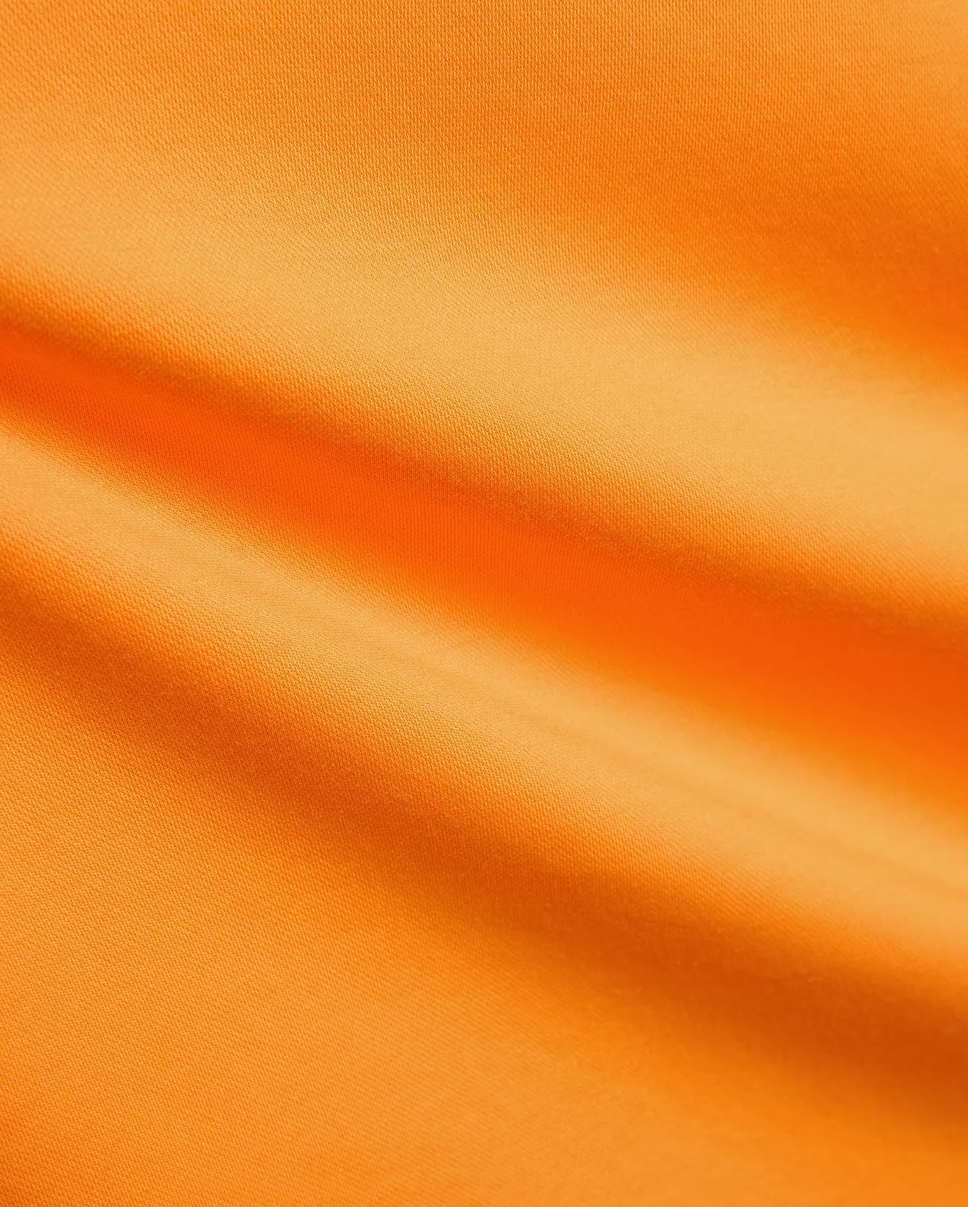 Vibrant orange Mens Big And Tall Joji Performance Polo with a pique knit texture, featuring the signature embroidered Psycho Bunny skull logo on the chest.