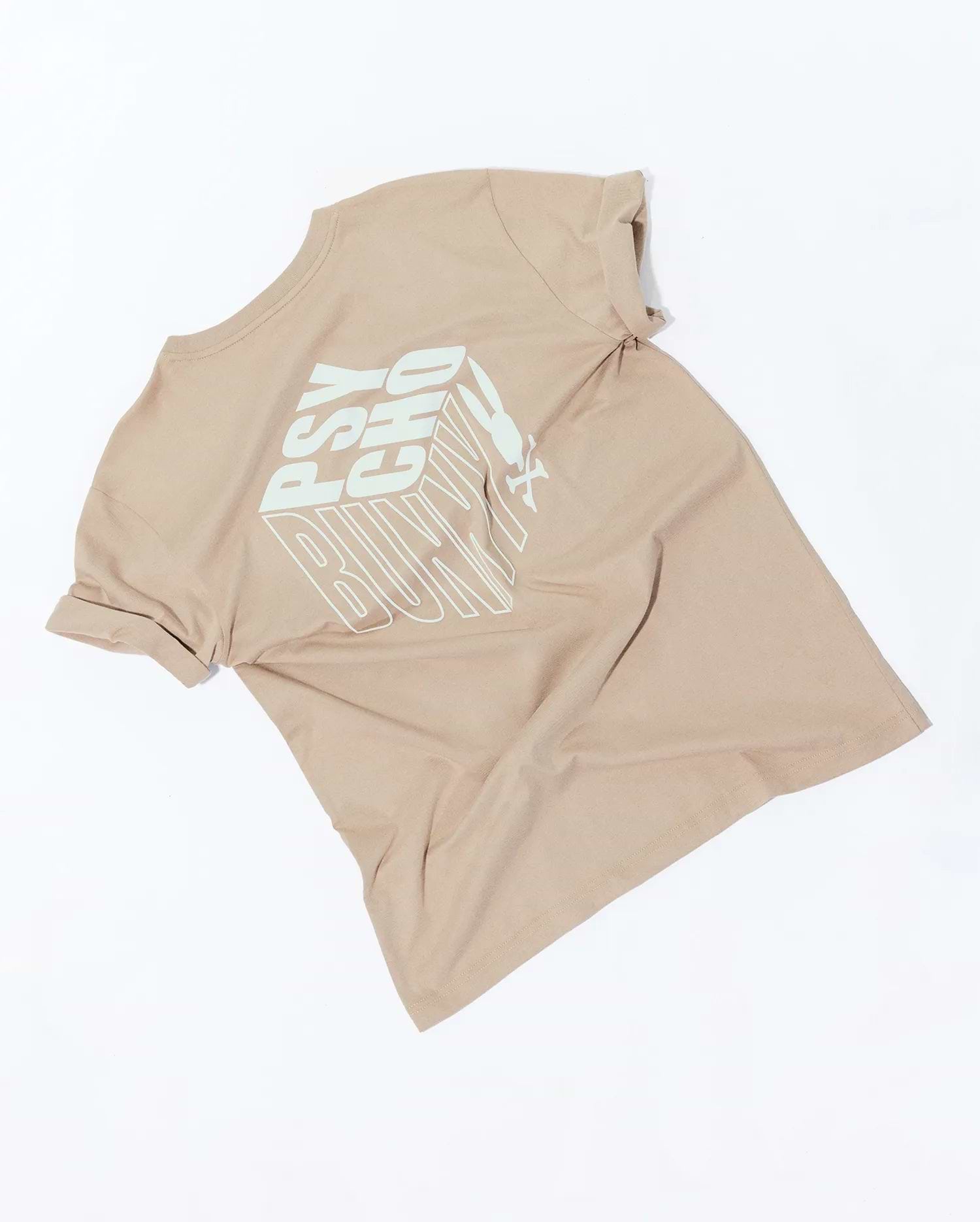 Men's Conan Pima Back Graphic Tee, a classic fit beige Pima cotton jersey t-shirt featuring a large mint green 3D block text PSYCHO BUNNY graphic on the back and subtly rolled sleeves.