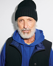 Black ribbed knit MENS BROGAN BEANIE with a subtle bunny skull logo patch, layered over a royal blue relaxed fit french terry hoodie and a black full-zip vest with a dark blue collar and branded snap button.