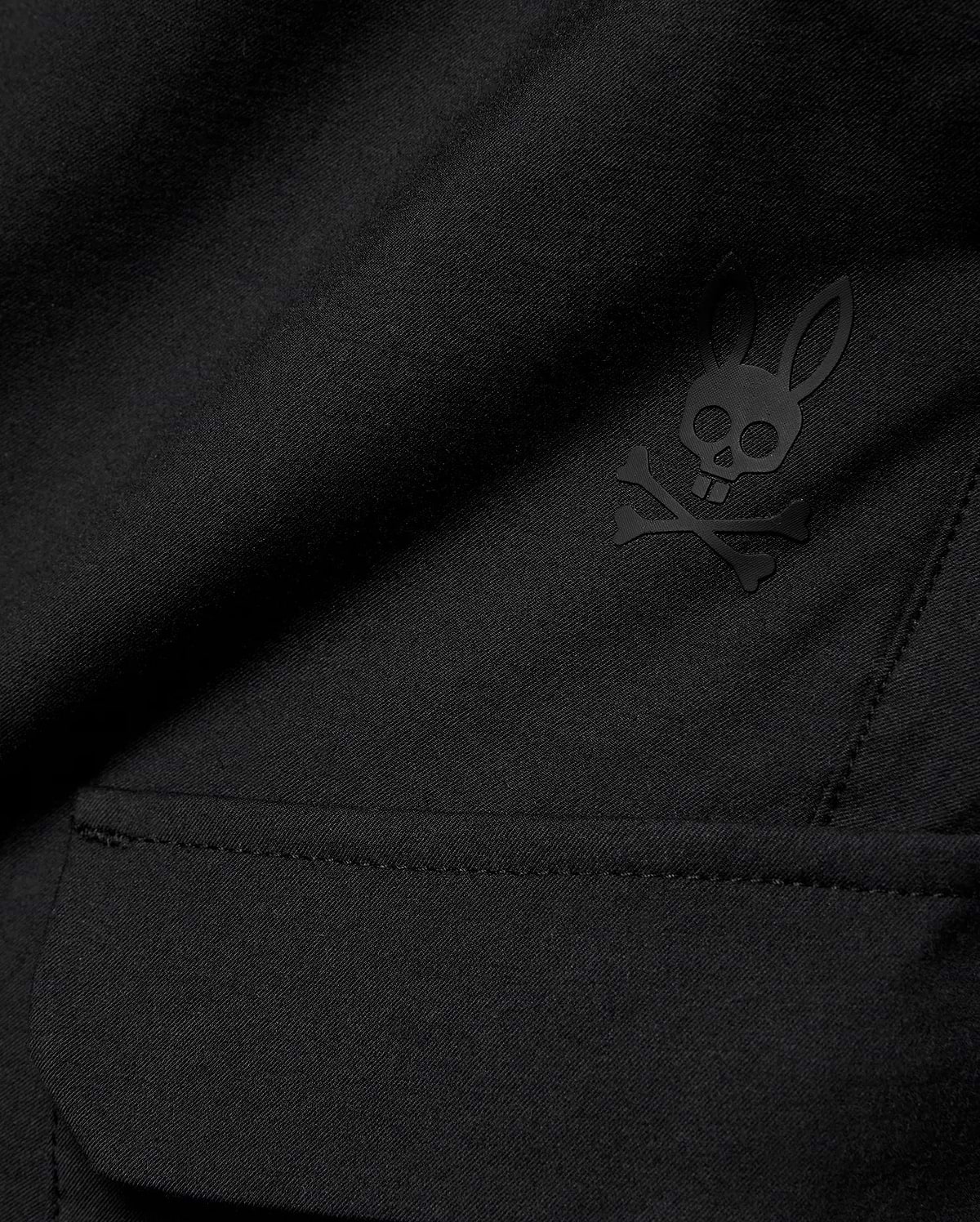 Kids Luka Cargo Pant in black woven fabric, featuring a tonal black Psycho Bunny skull and crossbones logo on the cargo pocket.