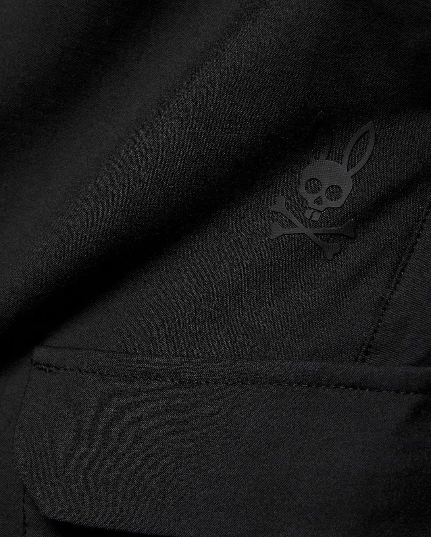 Kids Luka Cargo Pant in black woven fabric, featuring a tonal black Psycho Bunny skull and crossbones logo on the cargo pocket.