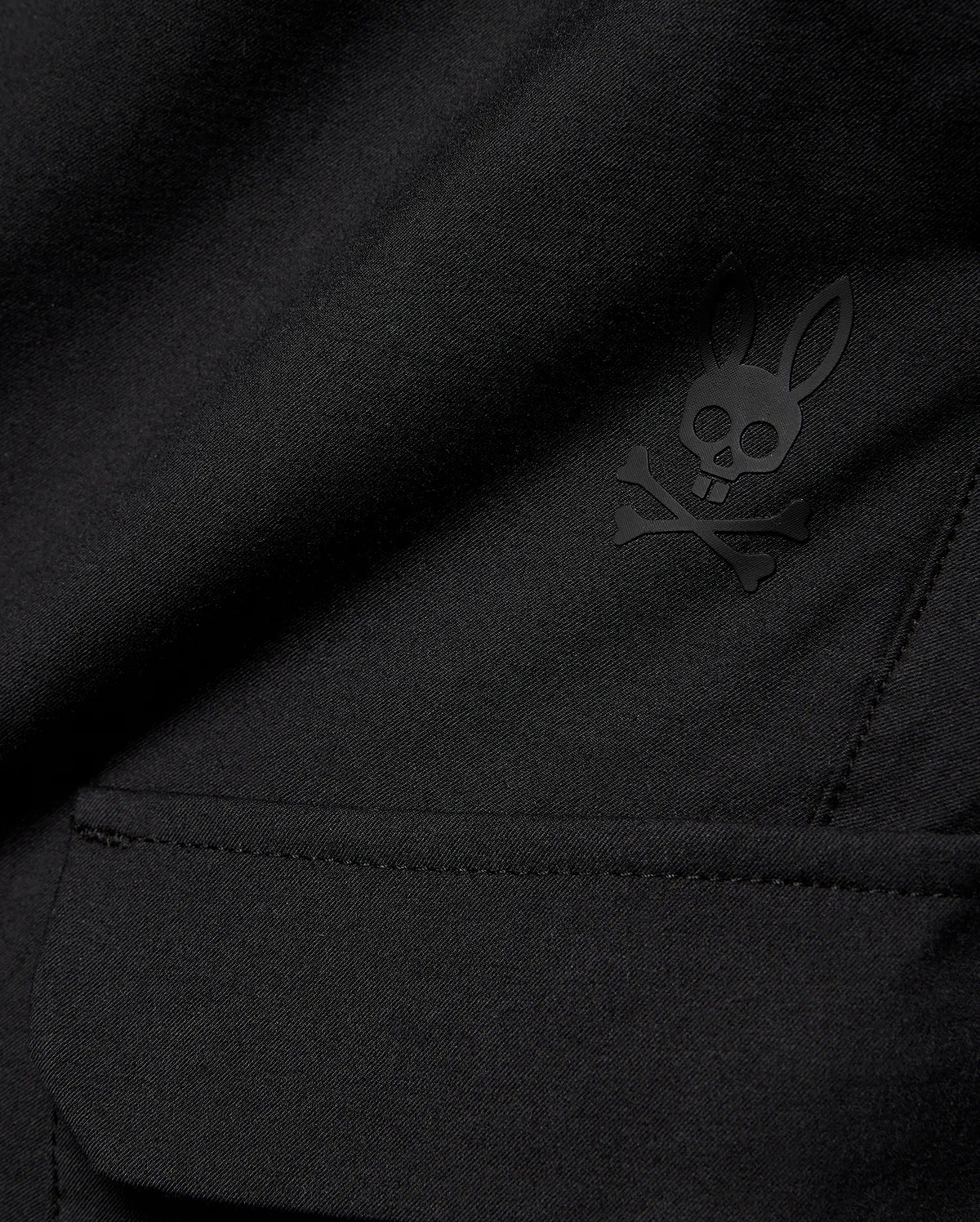 Kids Luka Cargo Pant in black woven fabric, featuring a tonal black Psycho Bunny skull and crossbones logo on the cargo pocket.