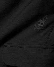 Kids Luka Cargo Pant in black woven fabric, featuring a tonal black Psycho Bunny skull and crossbones logo on the cargo pocket.