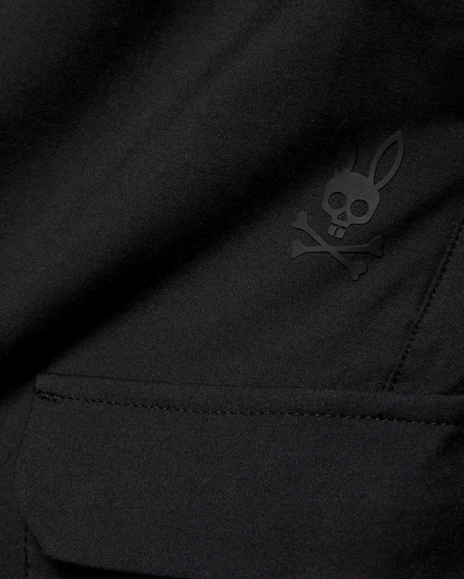 Kids Luka Cargo Pant in black woven fabric, featuring a tonal black Psycho Bunny skull and crossbones logo on the cargo pocket.