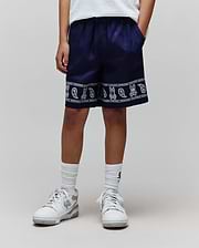 Kids Luke Tencel Short, navy relaxed-fit shorts with a white bandana-style print featuring repeated Psycho Bunny skull logos and paisley patterns along the hem, bordered by Psycho Bunny text.