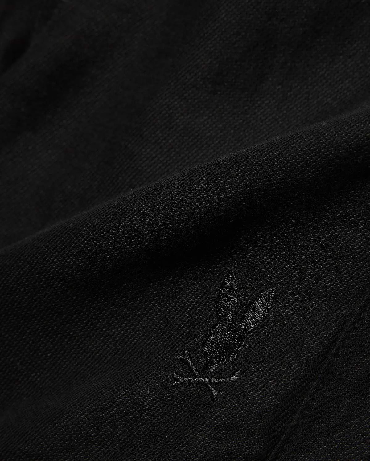 Kids Brad Linen Short in classic black, crafted from a breathable linen blend with a subtle woven texture, featuring a small, tonal embroidered Psycho Bunny skull logo.