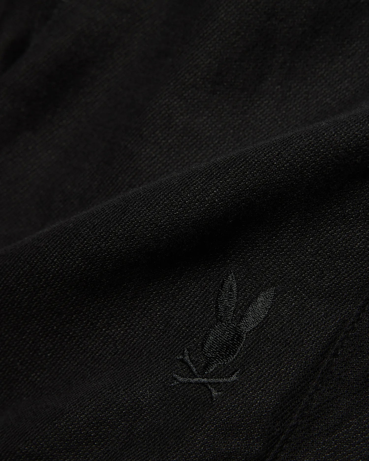 Kids Brad Linen Short in classic black, crafted from a breathable linen blend with a subtle woven texture, featuring a small, tonal embroidered Psycho Bunny skull logo.