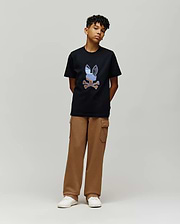 Black jersey t-shirt with a large, multi-color embroidered Psycho Bunny skull logo on the chest, paired with relaxed fit brown French terry Kids Nash Cargo Sweatpant featuring side cargo pockets.