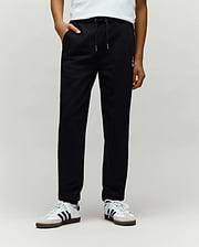 Kids Timothy 4k Bunny Jogger in black smooth jersey, featuring a relaxed fit, drawstring waist, side pockets, and a small white embroidered Psycho Bunny skull logo on the left thigh.