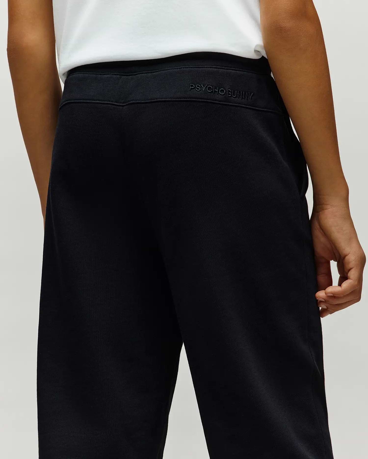 Kids Timothy 4k Bunny Jogger in black french terry, featuring a relaxed fit, subtle vertical ribbing, and tonal embroidered PSYCHO BUNNY text on the back waistband.