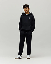 Black Kids Timothy 4k Bunny Jogger and matching hoodie, both featuring a small white embroidered Psycho Bunny skull logo on the left chest and left thigh, in a relaxed fit soft French terry fabric.