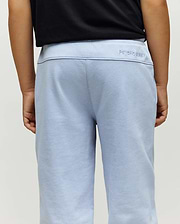 Kids Timothy 4K Bunny Jogger in a soft, light blue french terry fabric, featuring a relaxed fit and a subtle embroidered Psycho Bunny text logo on the back waistband.