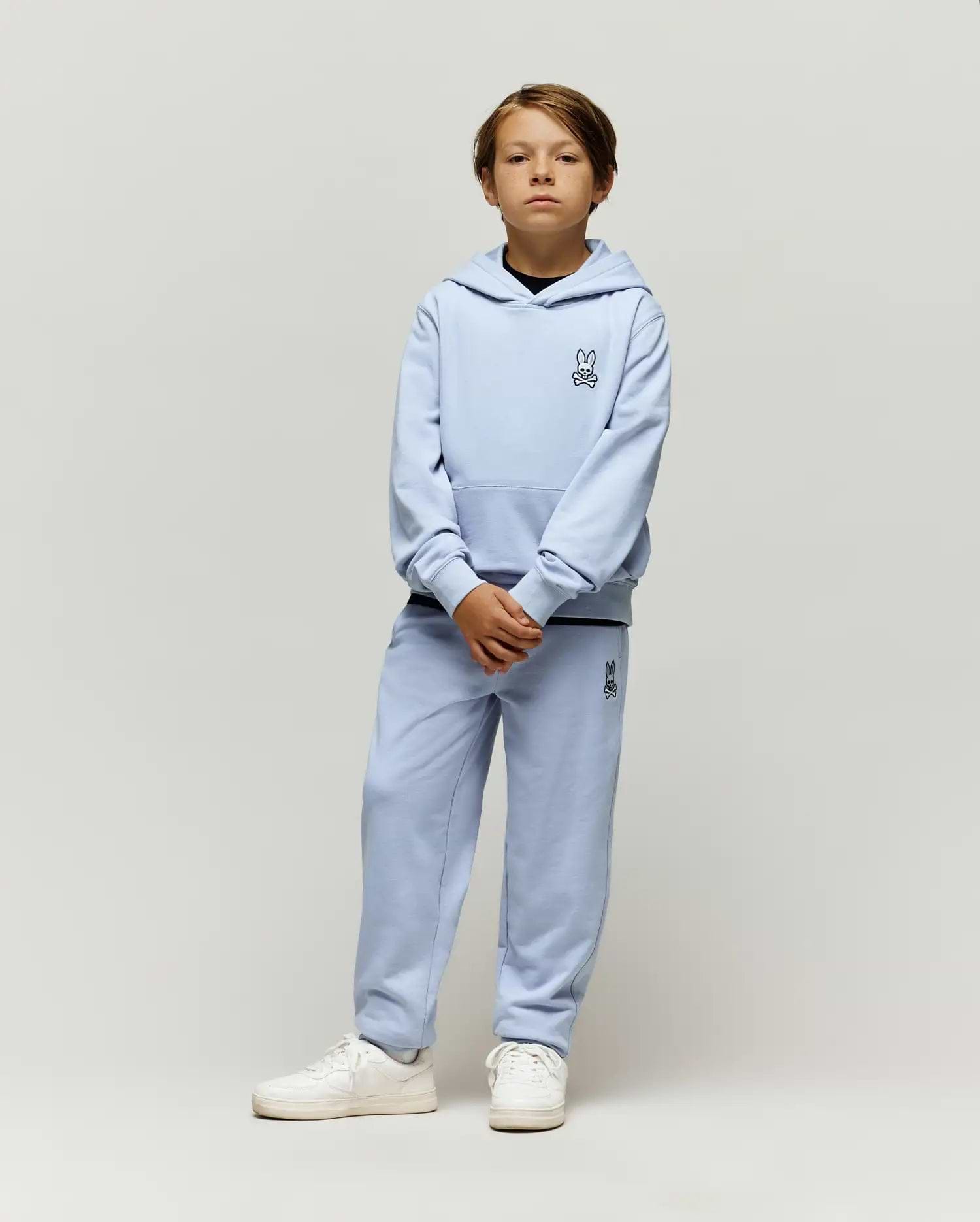 Light blue Kids Timothy 4k Bunny Jogger set, featuring a relaxed fit French terry hoodie with kangaroo pocket and matching joggers, both with small embroidered black Psycho Bunny skull logos.