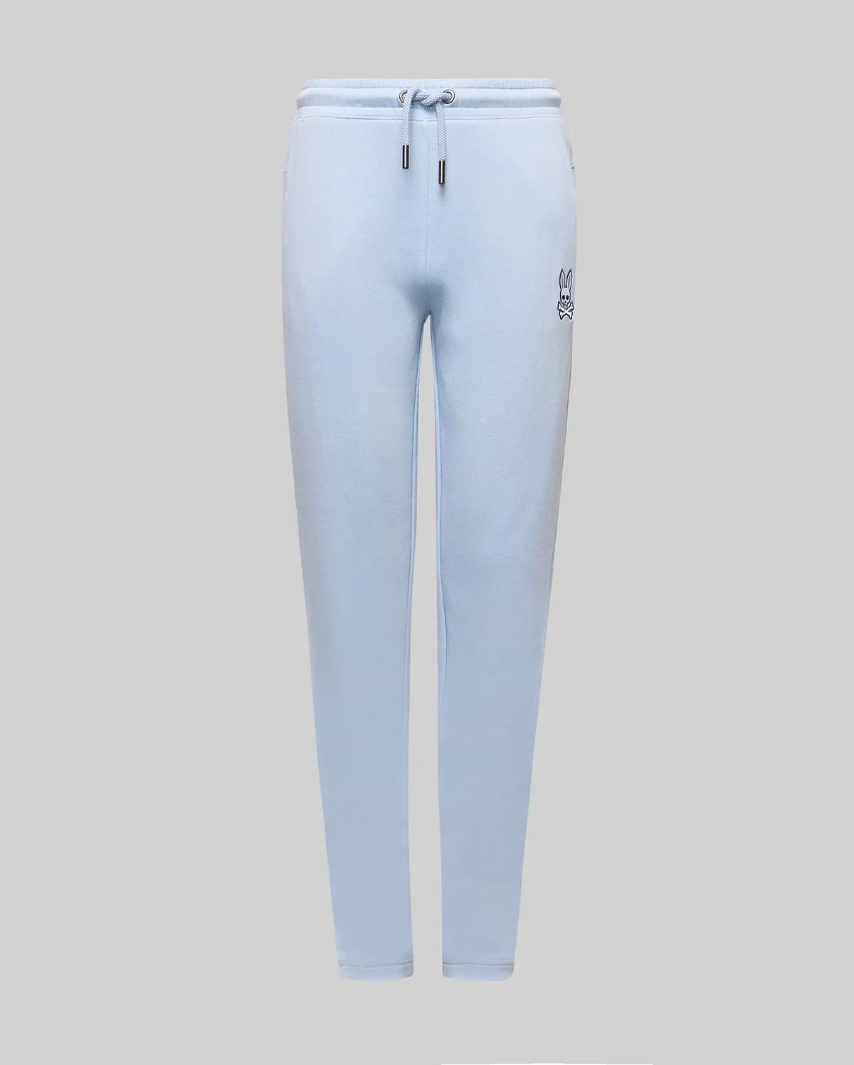 Kids Timothy 4K Bunny Jogger in light blue french terry, featuring a relaxed fit, drawstring waist with silver tips, and a small, embroidered dark blue Psycho Bunny skull logo on the left thigh.