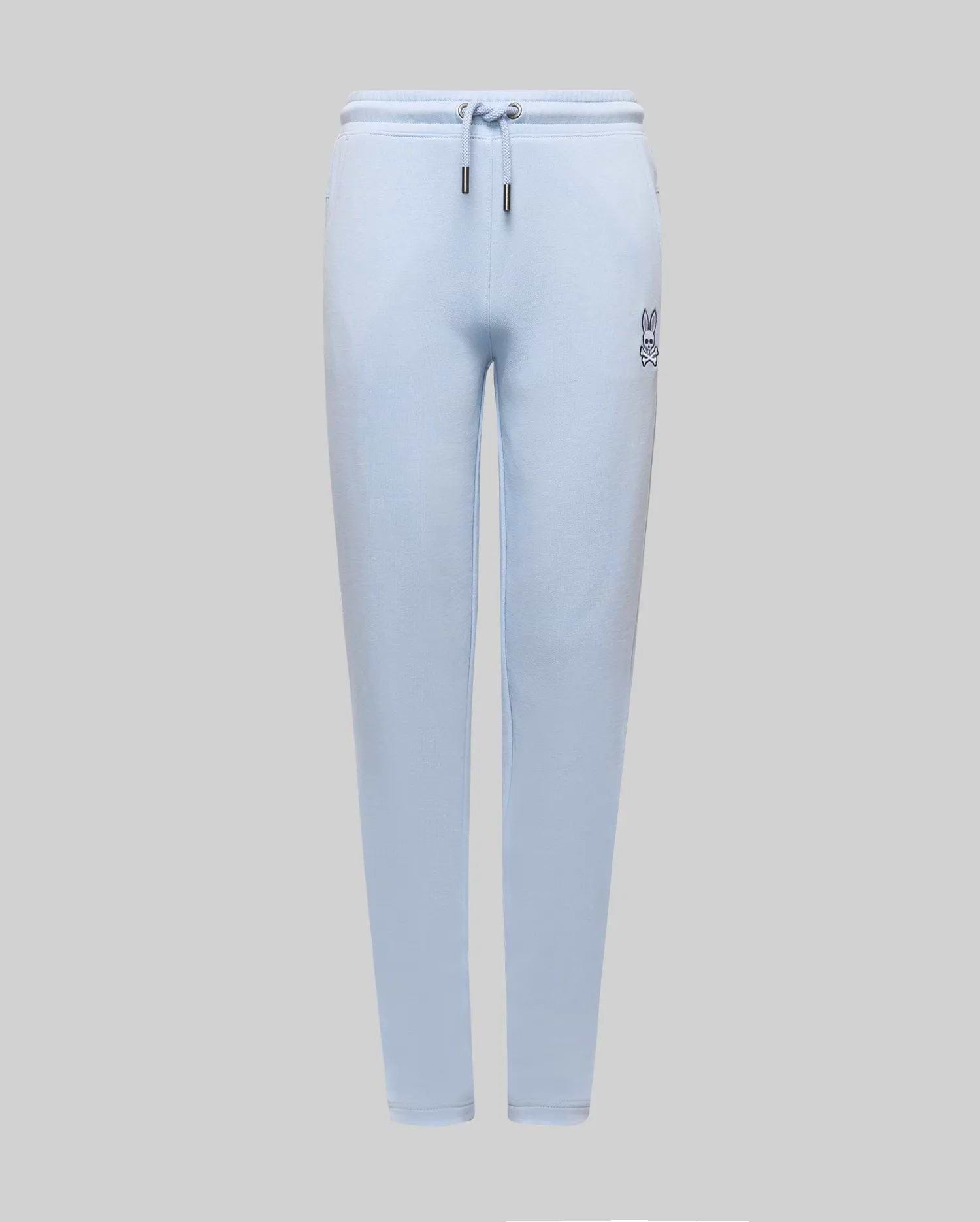 Kids Timothy 4K Bunny Jogger in light blue french terry, featuring a relaxed fit, drawstring waist with silver tips, and a small, embroidered dark blue Psycho Bunny skull logo on the left thigh.
