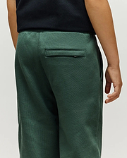 Kids Tate Chenille Sweatpant in deep forest green, featuring a relaxed fit, soft chenille knit texture, elasticated waist, and a small Psycho Bunny logo tag on the back right welt pocket.