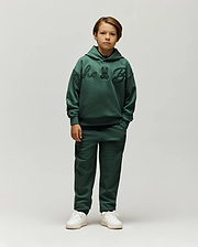 Forest green relaxed fit french terry hoodie with large tonal chenille Psycho Bunny script and skull logo on chest, paired with Kids Tate Chenille Sweatpant featuring a small tonal bunny skull logo.