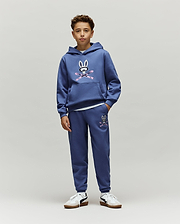 Indigo blue relaxed fit french terry hoodie and Kids Indigo Ski Bunny Sweatpant set, featuring a large chest and smaller left thigh Psycho Bunny skull logo with pink ski goggles and crossed skis.