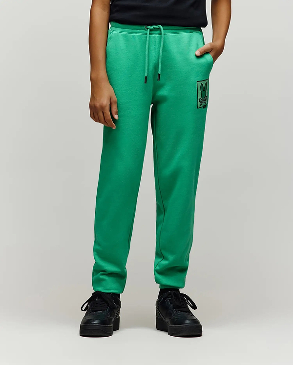 Kids Varen Jogger in bright green french terry, featuring a relaxed fit, drawstring waist with black tips, and a prominent black rectangular Psycho Bunny skull logo patch on the left thigh.