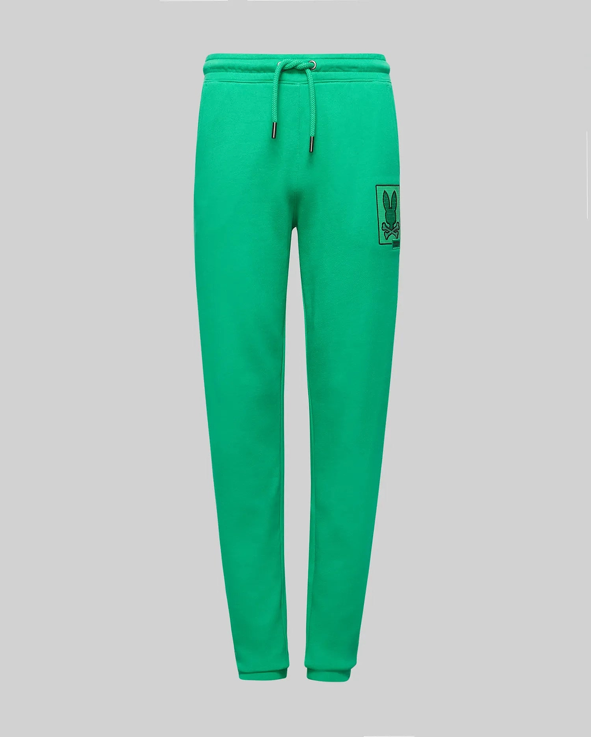 Bright green Kids Varen Jogger with a relaxed fit, smooth jersey fabric, drawstring waist, and a black outline Psycho Bunny skull logo on a square patch on the right thigh.