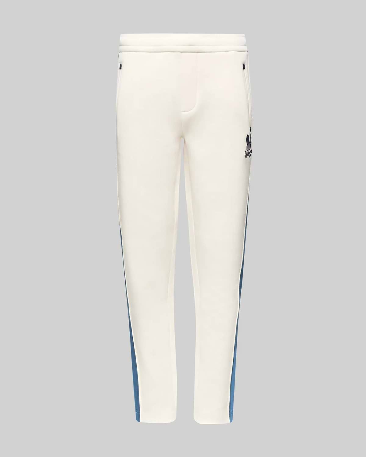 Kids Caspian Contrast Stripe Track Pant in cream, featuring a blue side stripe, relaxed fit, smooth fabric, and a small black embroidered Psycho Bunny skull logo on the upper right thigh.