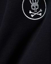 Kids Nathaniel Sweatpant in deep navy blue, crafted from soft jersey knit fabric, featuring a prominent white embroidered Psycho Bunny skull and crossbones logo.