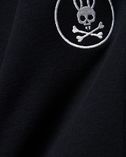 Kids Nathaniel Sweatpant in deep navy blue, crafted from soft jersey knit fabric, featuring a prominent white embroidered Psycho Bunny skull and crossbones logo.