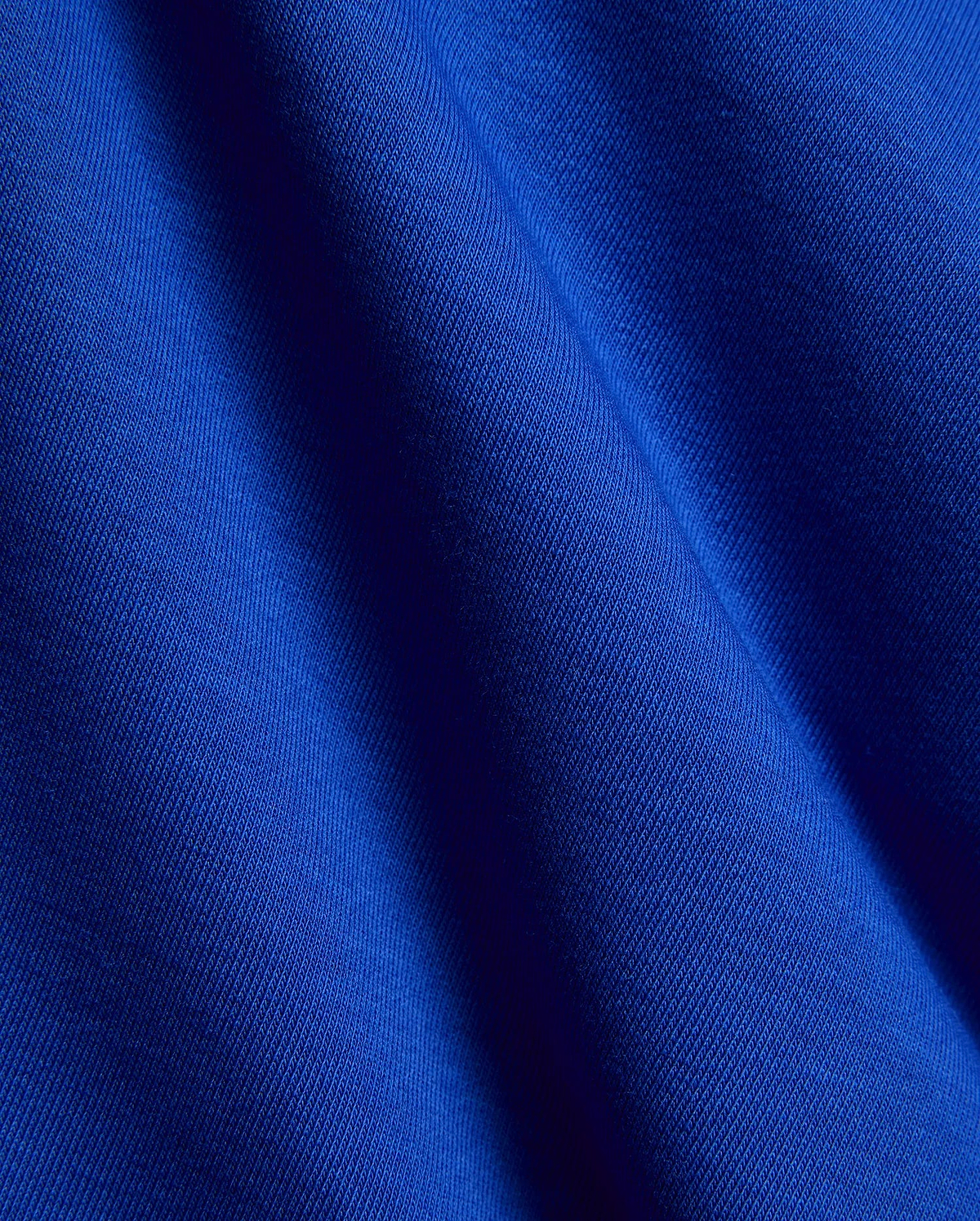 Kids Nathaniel Sweatpant in vibrant royal blue, crafted from a premium, soft jersey knit fabric with a subtle diagonal texture and elegant drape, reflecting refined streetwear quality.