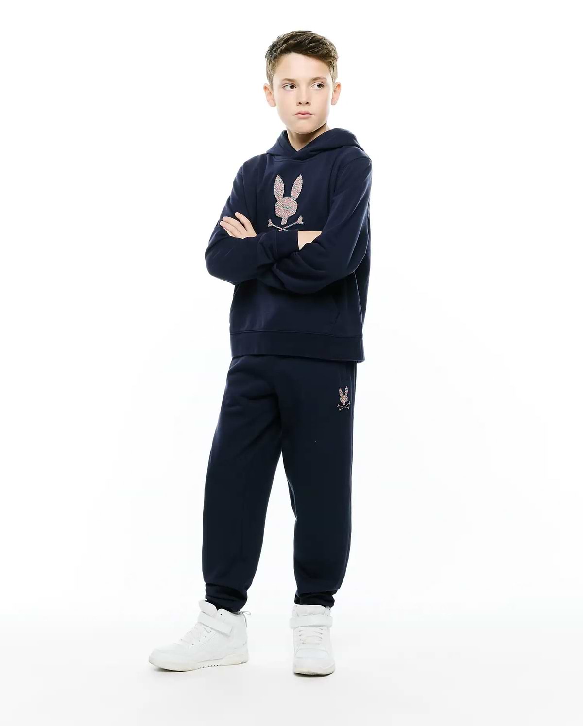 Navy blue relaxed fit hoodie with a large multicolor embroidered Psycho Bunny skull logo on the chest, paired with matching Kids Darcy Sweatpant featuring a small multicolor logo on the left thigh.