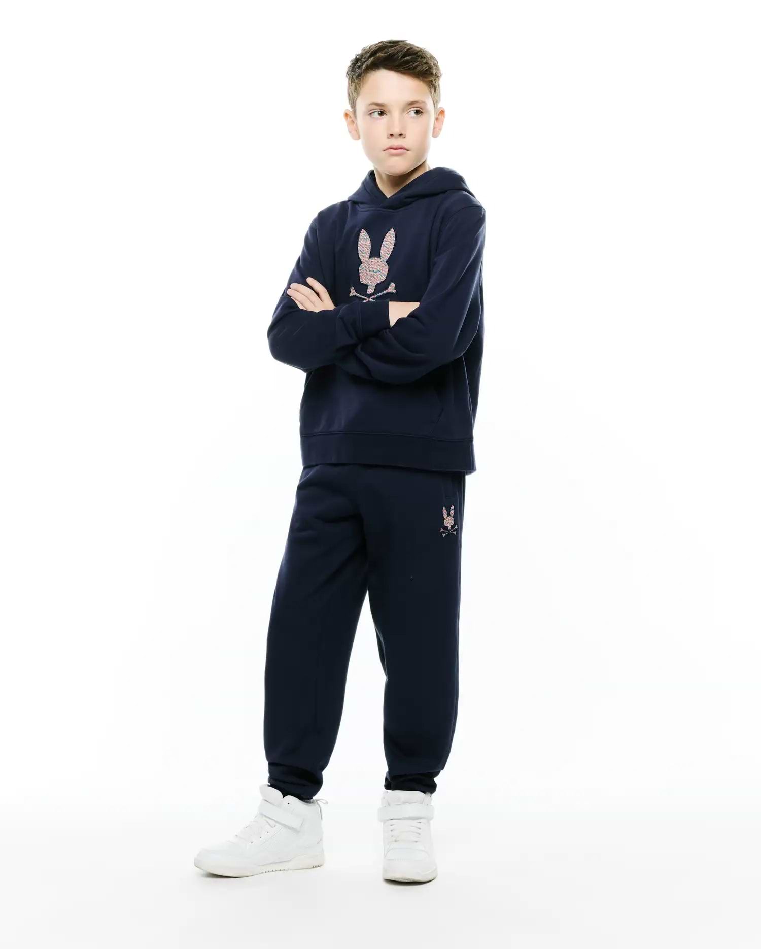 Navy blue relaxed fit hoodie with a large multicolor embroidered Psycho Bunny skull logo on the chest, paired with matching Kids Darcy Sweatpant featuring a small multicolor logo on the left thigh.