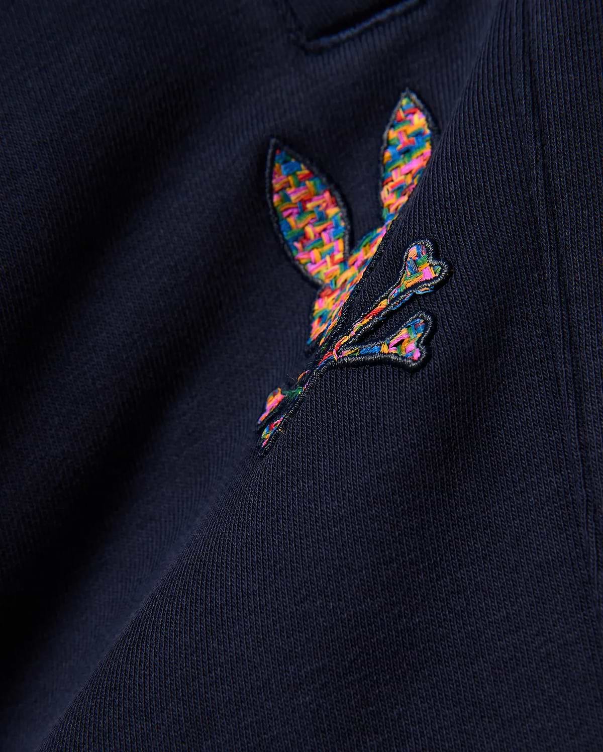 Kids Darcy Sweatpant in deep navy, crafted from soft jersey knit fabric, prominently featuring a medium-sized, intricately embroidered multicolor Psycho Bunny skull logo with a vibrant, woven texture.