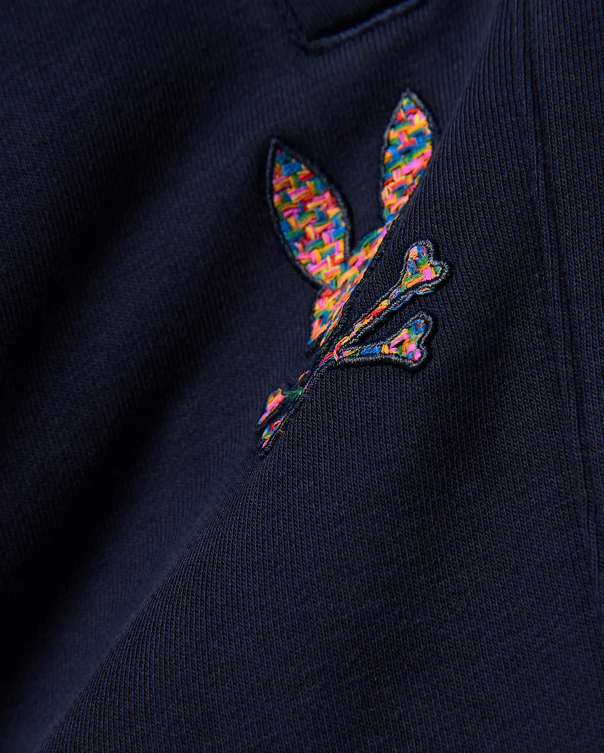 Kids Darcy Sweatpant in deep navy, crafted from soft jersey knit fabric, prominently featuring a medium-sized, intricately embroidered multicolor Psycho Bunny skull logo with a vibrant, woven texture.