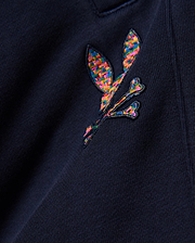 Kids Darcy Sweatpant in deep navy, crafted from soft jersey knit fabric, prominently featuring a medium-sized, intricately embroidered multicolor Psycho Bunny skull logo with a vibrant, woven texture.