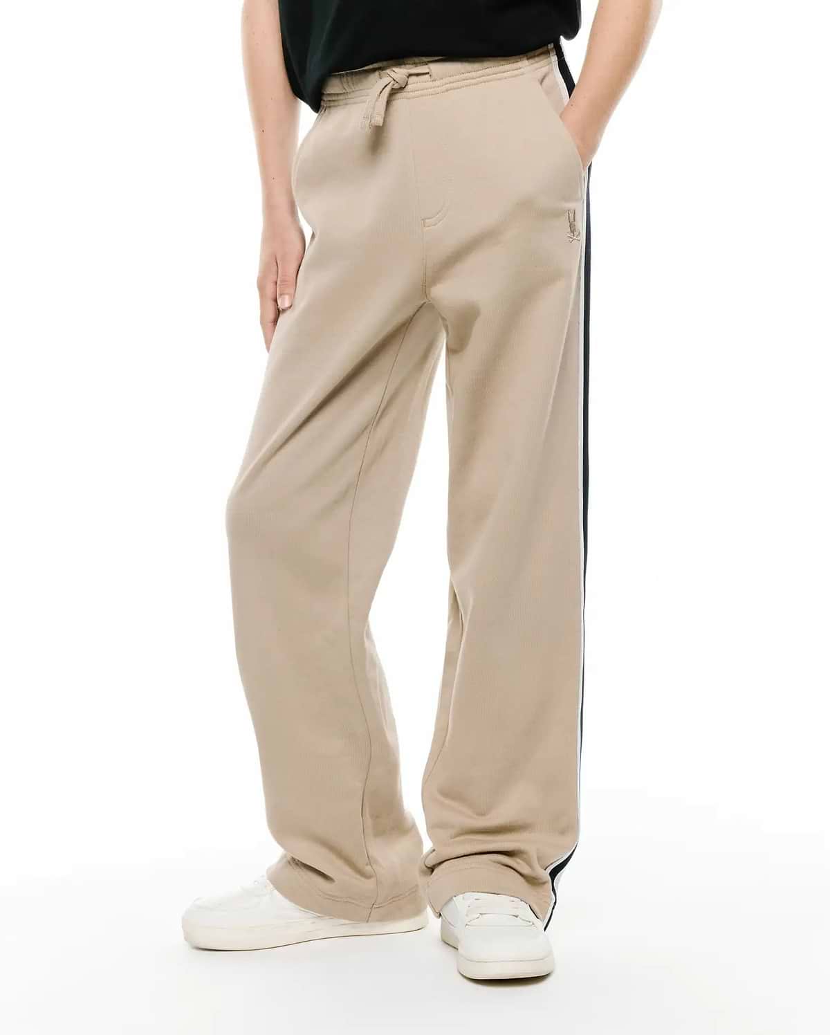 Kids Ty French Terry Sweatpant, beige relaxed fit with drawstring waist, side pockets, dark blue and white side stripe, and small embroidered Psycho Bunny logo.