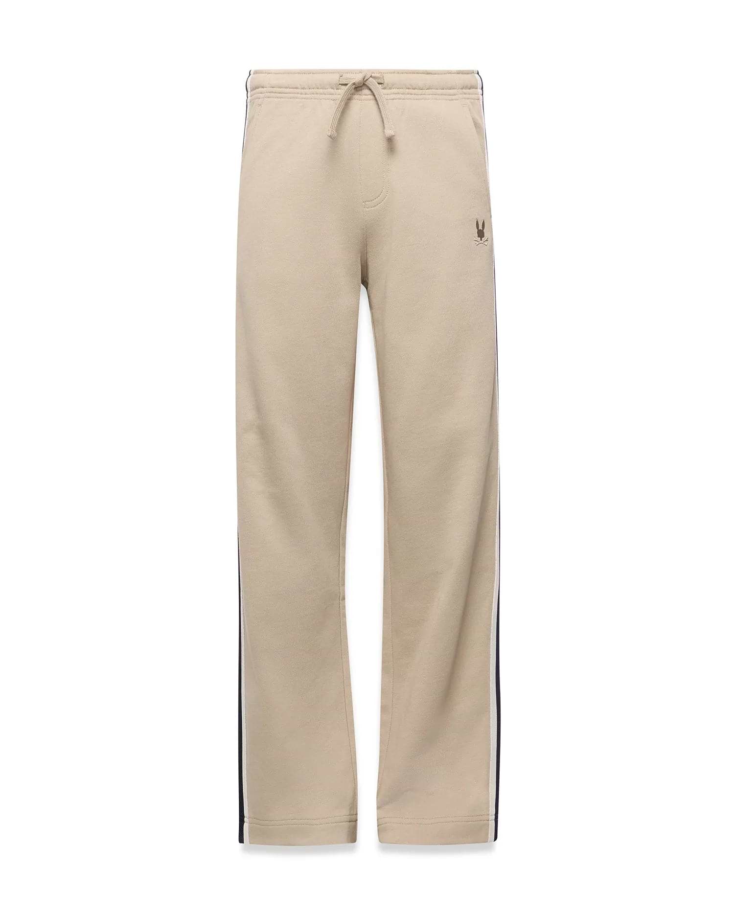 Kids Ty French Terry Sweatpant in beige, featuring a relaxed fit, drawstring waist, navy and white side stripes, and a small embroidered Psycho Bunny skull logo on the upper right thigh.