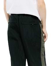 Kids Alder Nylon Colorblock Pant in dark green crinkled nylon with olive green side panels and back flap pockets, featuring a relaxed fit.