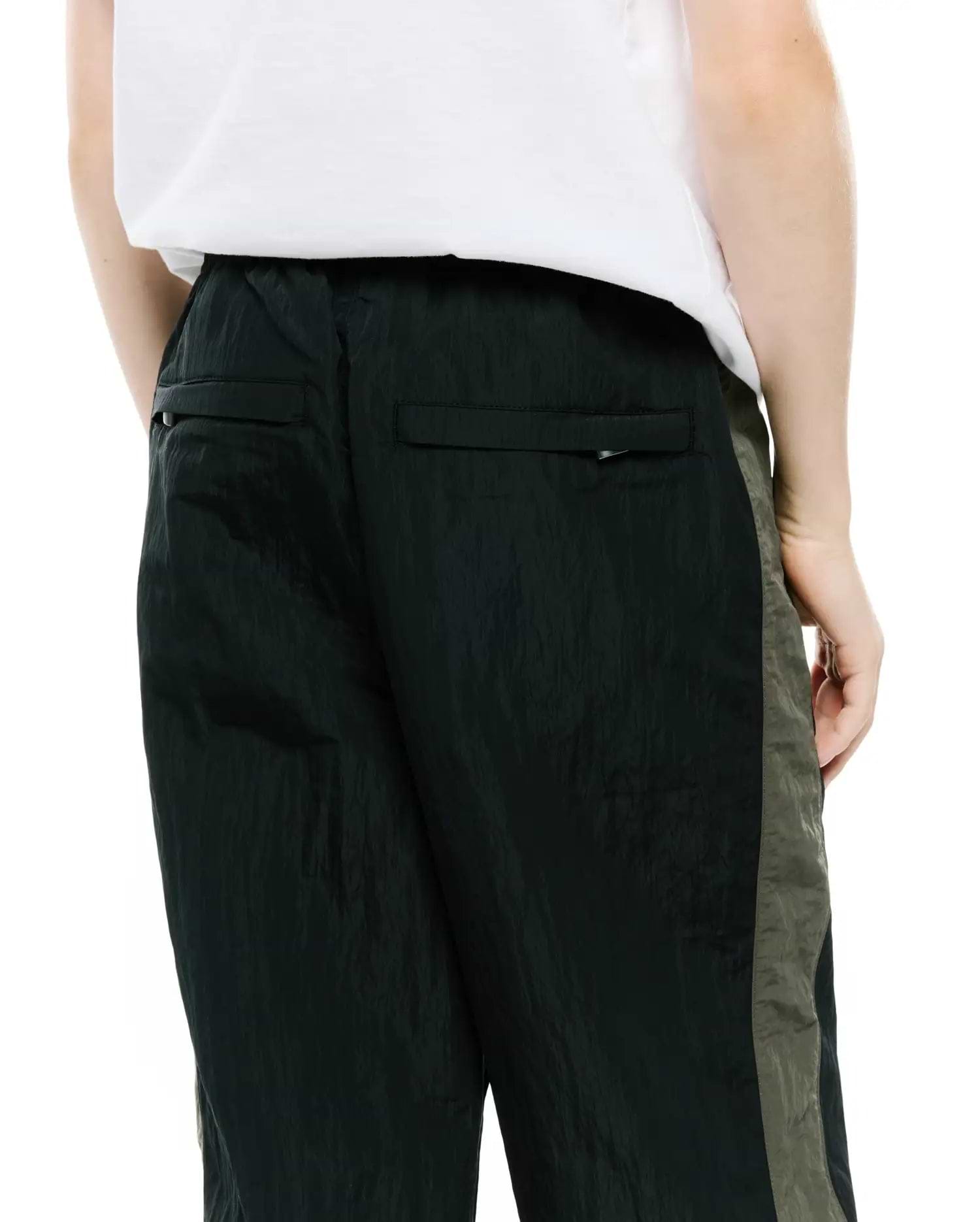 Kids Alder Nylon Colorblock Pant in dark green crinkled nylon with olive green side panels and back flap pockets, featuring a relaxed fit.