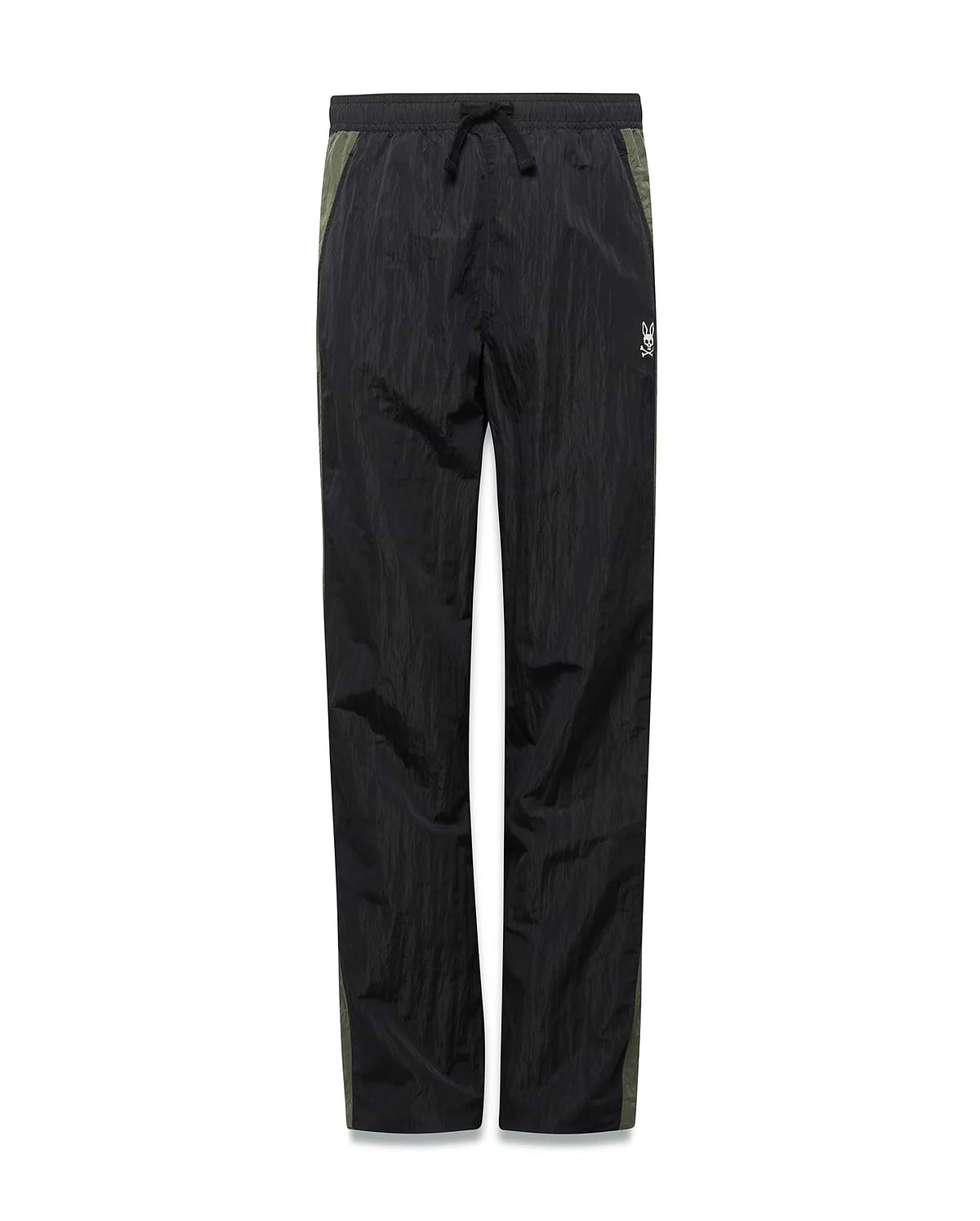 Kids Alder Nylon Colorblock Pant in black crinkled nylon with olive green side panels, featuring a relaxed fit and a small white Psycho Bunny skull logo on the right hip.