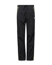 Kids Alder Nylon Colorblock Pant in black crinkled nylon with olive green side panels, featuring a relaxed fit and a small white Psycho Bunny skull logo on the right hip.