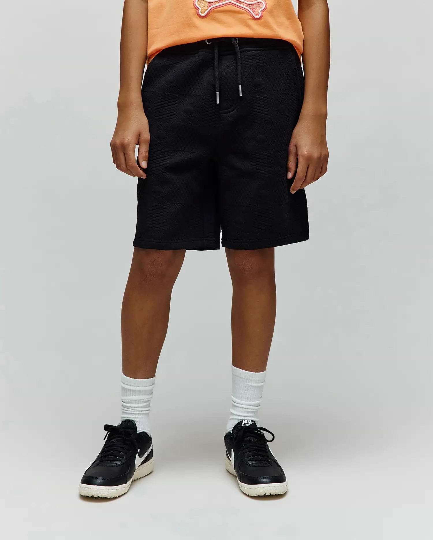 Kids Dustin Sweatshort, a premium black relaxed-fit sweatshort featuring a unique all-over quilted texture and an adjustable drawstring waist for refined streetwear style.