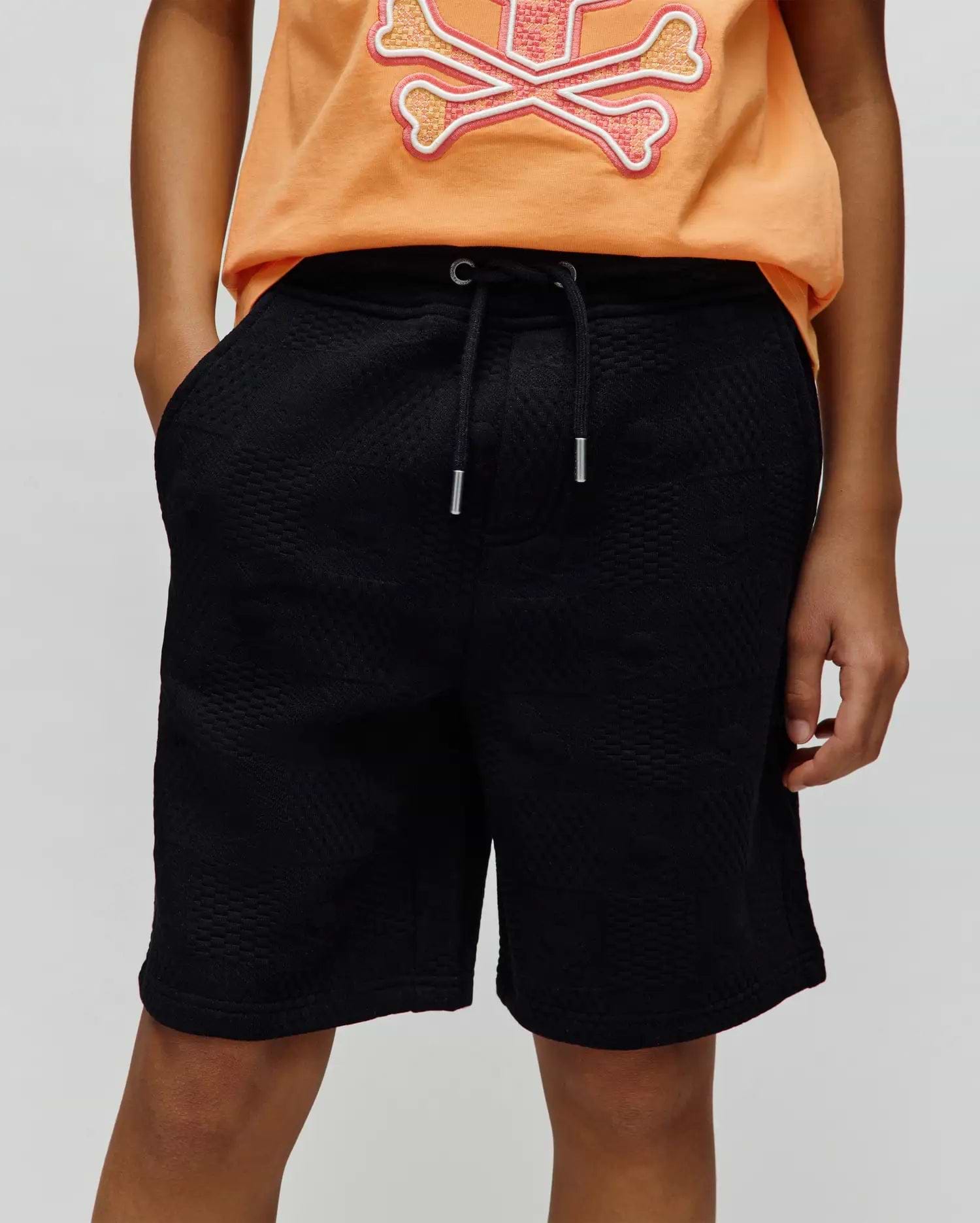 Kids Dustin Sweatshort, a premium black textured knit with a subtle geometric pattern, offering a relaxed fit and an adjustable drawstring waist with sleek silver-tipped cords.