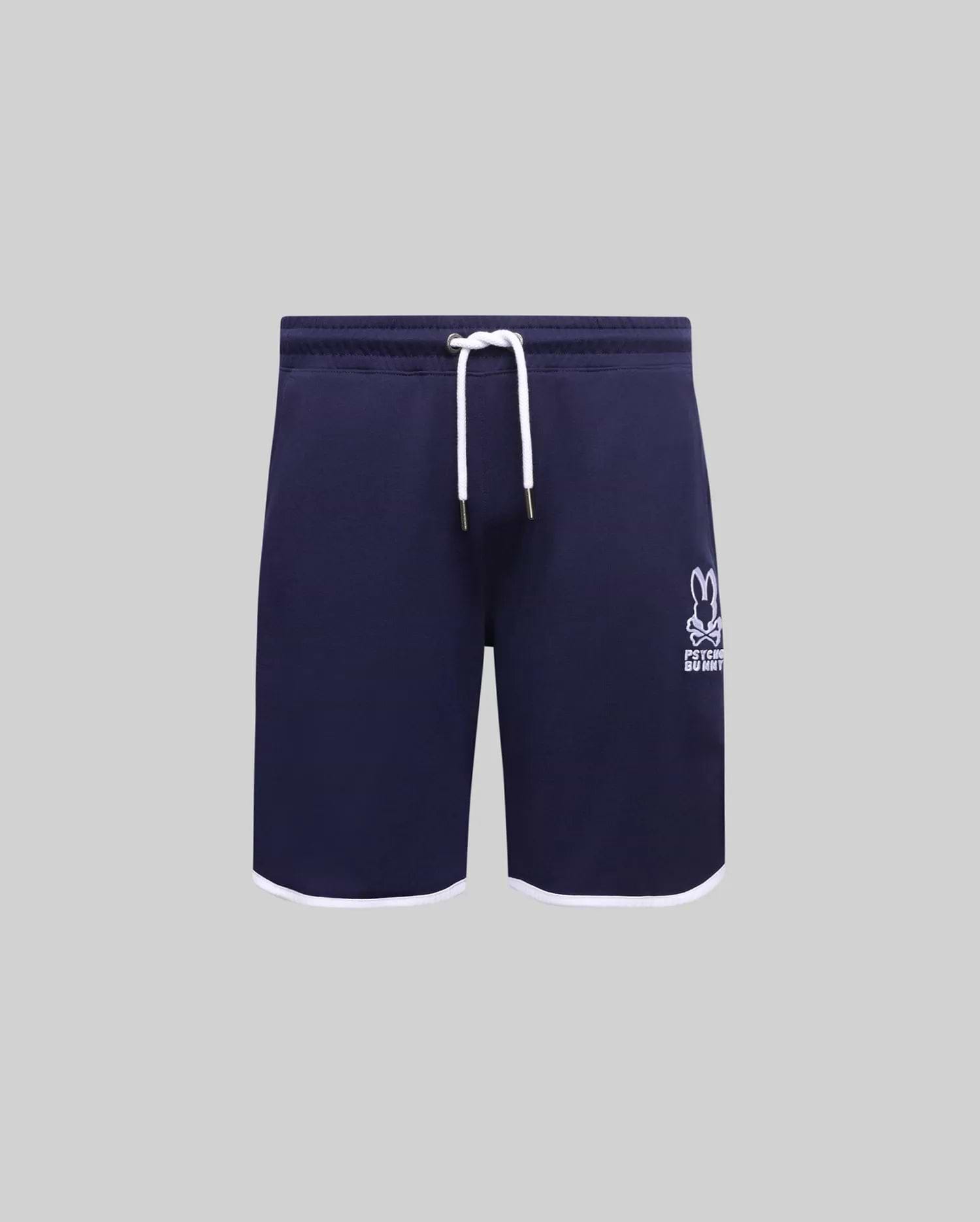 Kids Toby Short, navy French terry with white drawstring, gold tips, and white hem trim. Features an embroidered white Psycho Bunny skull logo on the right thigh.