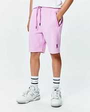 Kids Keith Short, a relaxed fit lavender pique short featuring a dark purple drawstring, side pockets, and a small embroidered Psycho Bunny skull logo on the lower left leg.