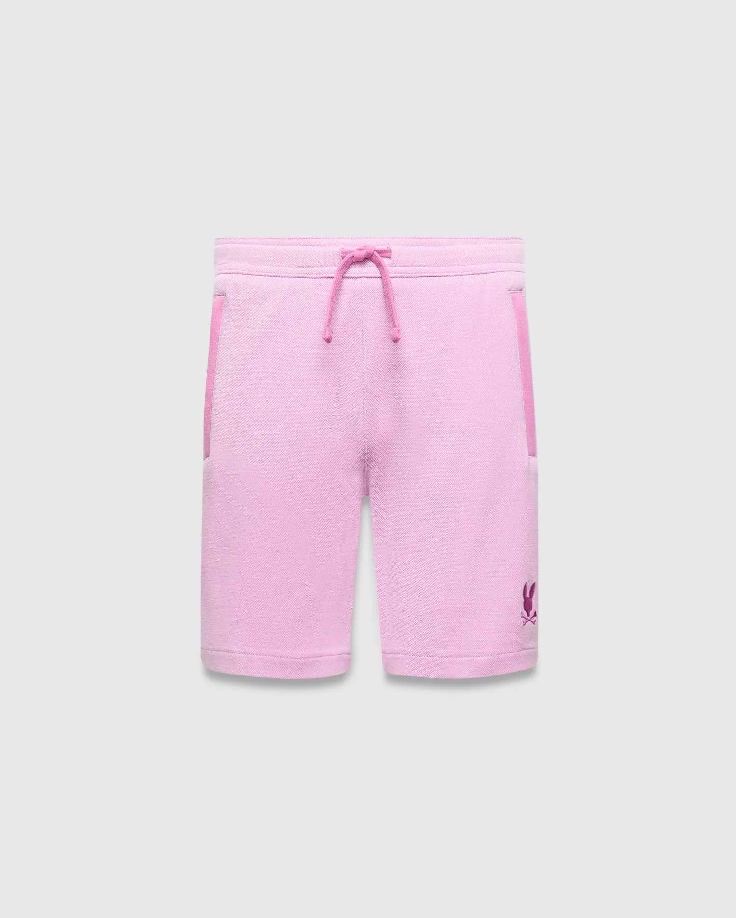 Kids Keith Short, a relaxed fit pink jersey short with magenta drawstring, side pocket trim, and a small embroidered Psycho Bunny skull logo on the lower left leg.